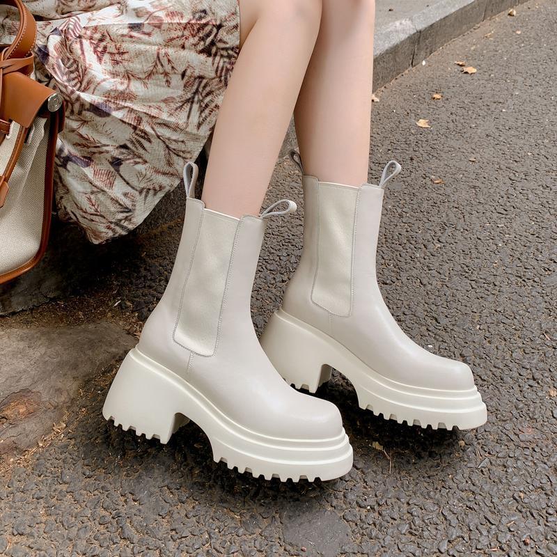 Cream chunky Chelsea boots worn outdoors