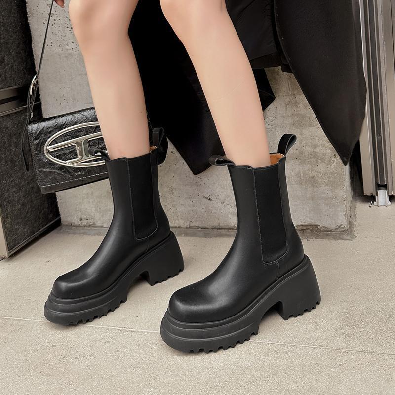 Black chunky Chelsea boots worn outdoors
