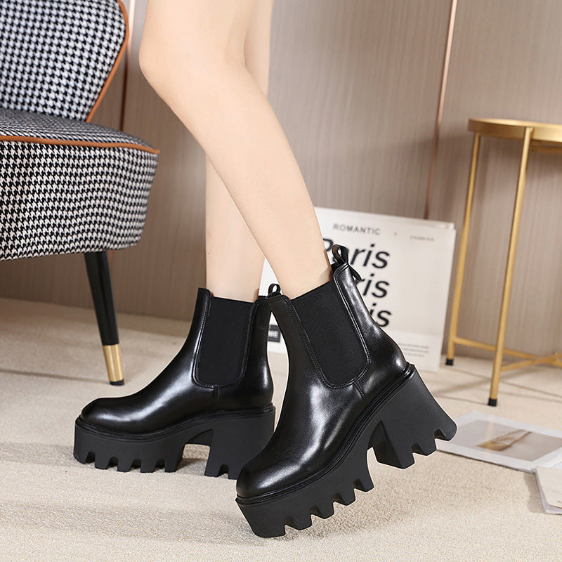 Black platform heel Chelsea boots worn indoors