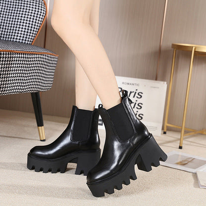 Black platform heel Chelsea boots worn indoors