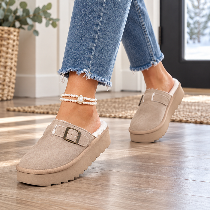 Women's taupe buckle platform clog mules worn at home