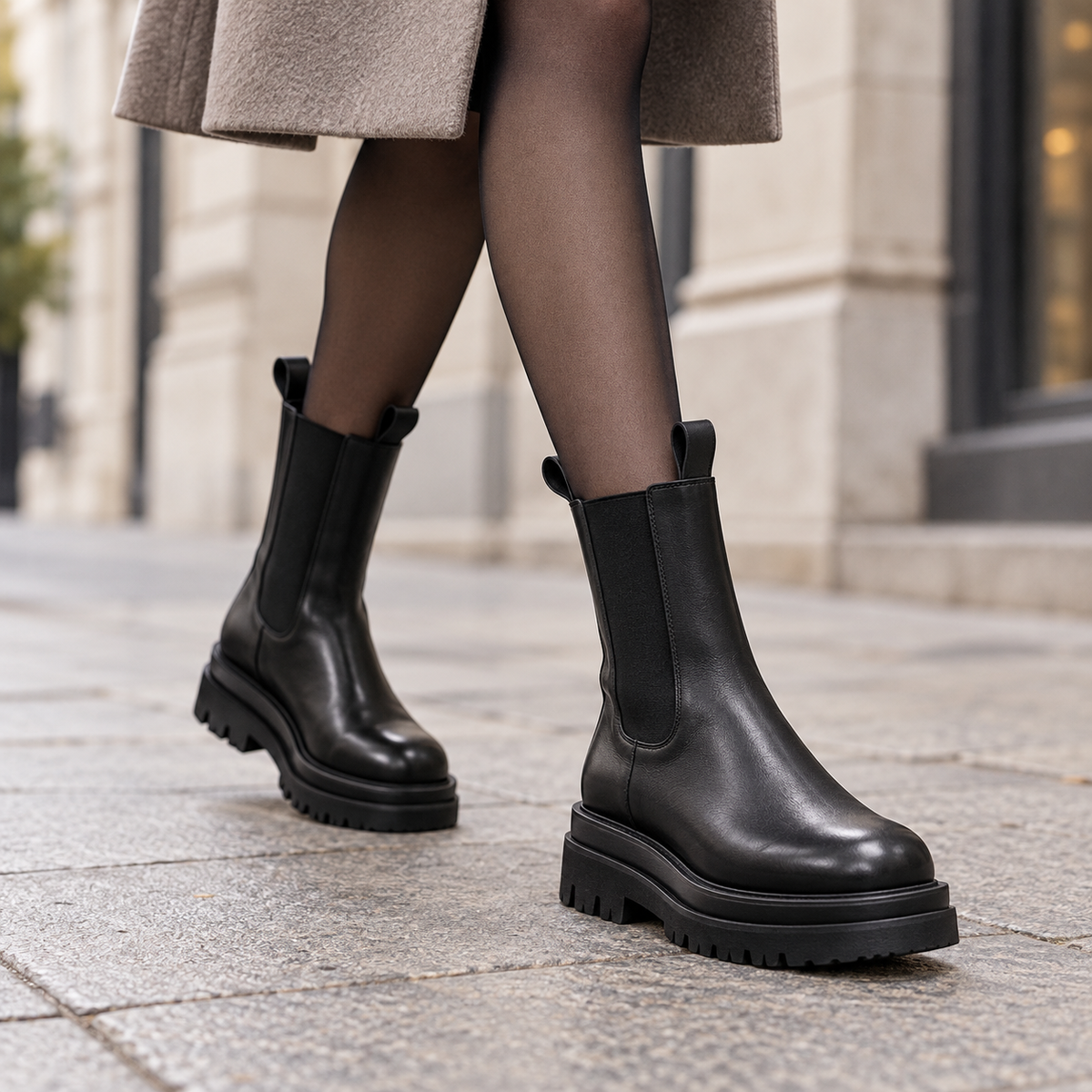 Women's black mid-calf Chelsea boots worn in the city