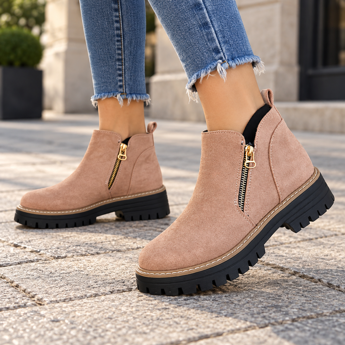 Pink suede-look side-zip ankle boots worn on feet