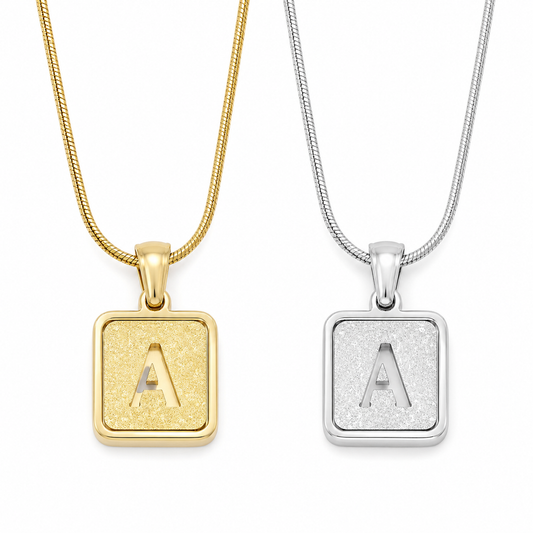 square initial necklace on white background