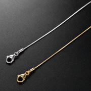 Silver and gold-tone 0.9mm square snake chain clasp detail