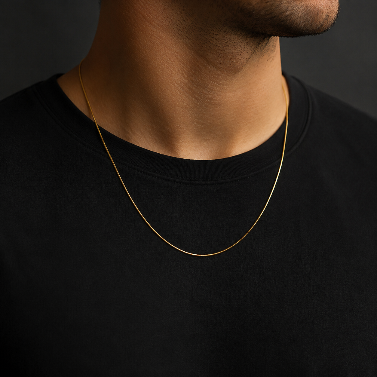 Man wearing a fine gold-tone 0.9mm square snake chain