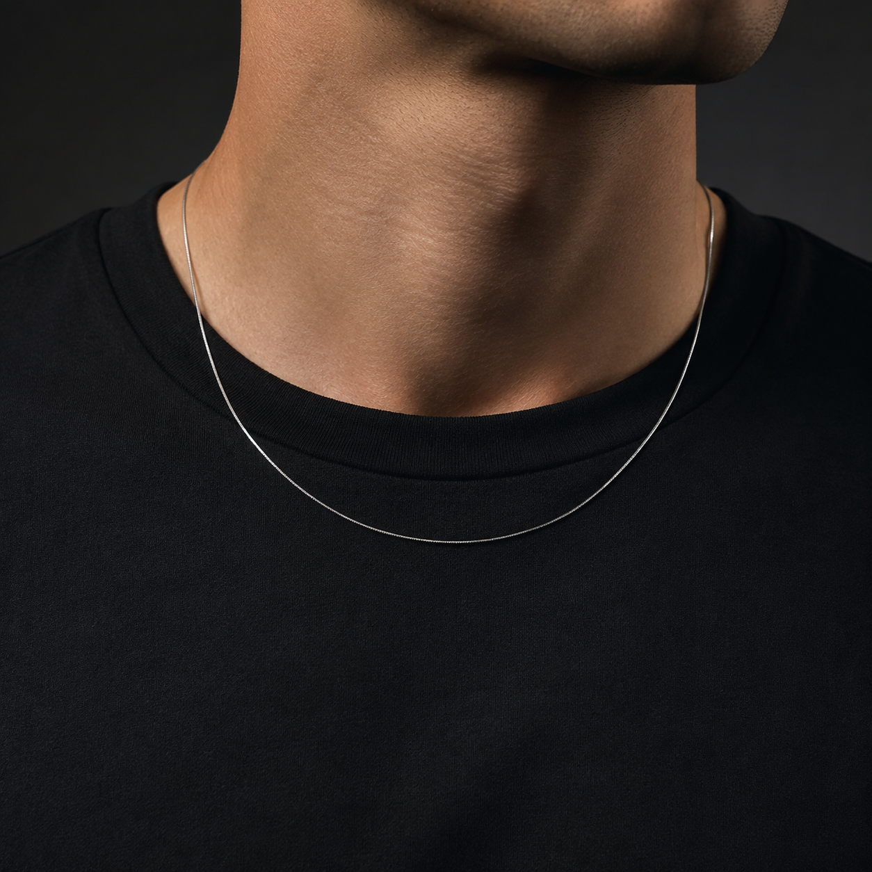 Man wearing a fine silver-tone 0.9mm square snake chain
