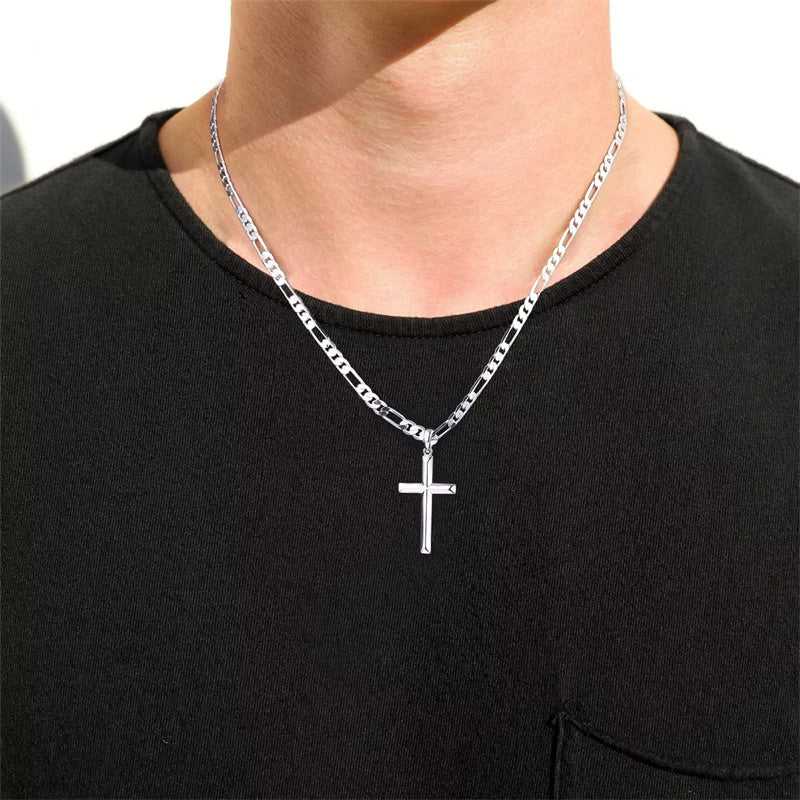 Man wearing a silver cross pendant on a Figaro chain