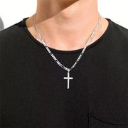 Man wearing a silver cross pendant on a Figaro chain