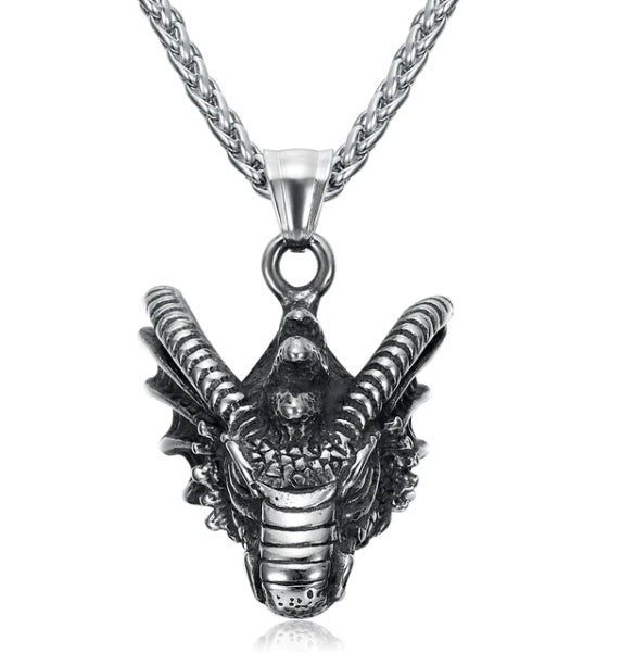 Antiqued basilisk head pendant necklace on white